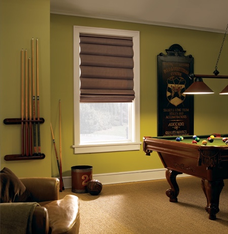 Roman shades in Fort Myers game room with green walls.